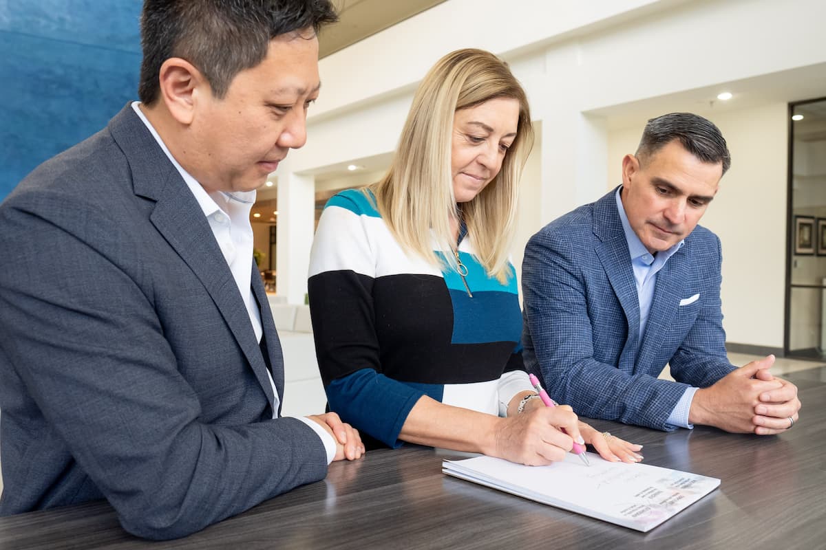 Paul Wang, Lori Jones, and Aaron Catoe review notes during a meeting